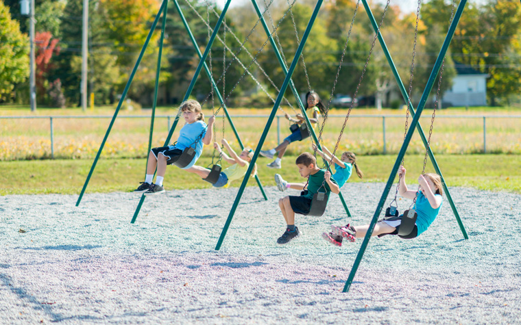 children on swings enjoying extra recess