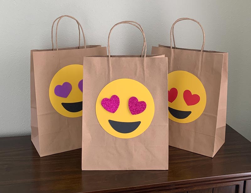 dorable emoji Valentine treat bag takes center stage featuring yellow background with a large red heart-shaped mouth and rosy cheeks