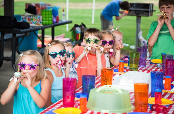 kids at a picnic style party signifying a back to school party