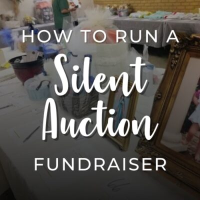 How to run a silent auction fundraiser, showing a table with various gift baskets and items arranged for bidding at a fundraising event.